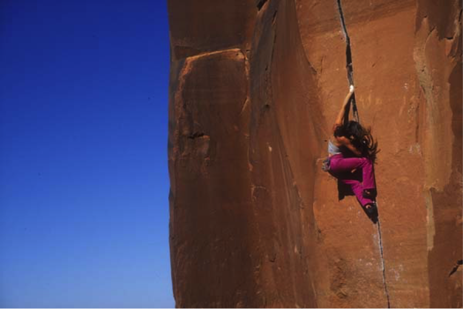 Steph Davis going thumbs down while soloing Scarface